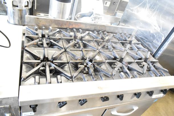 US Range commercial countertop gas-powered 8 burner range, featuring heavy-duty cast iron grates. Good condition.