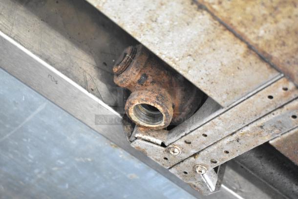 US Range Gas 8-Burner Range, rusty pipe and metal with visible wear. Ideal for parts or restoration.