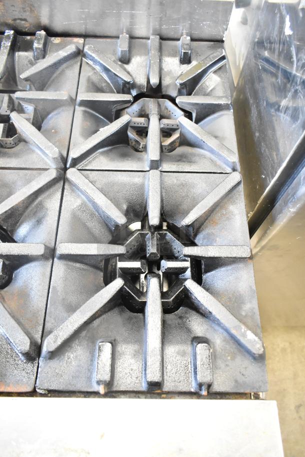 US Range commercial 8 burner gas countertop range, features durable cast iron grates, used condition.