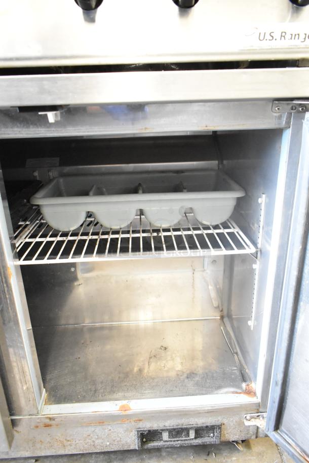 Ikon IUC48R 2-door undercounter cooler, 115V, stainless steel, visible wear and rust, interior shelf and container included.