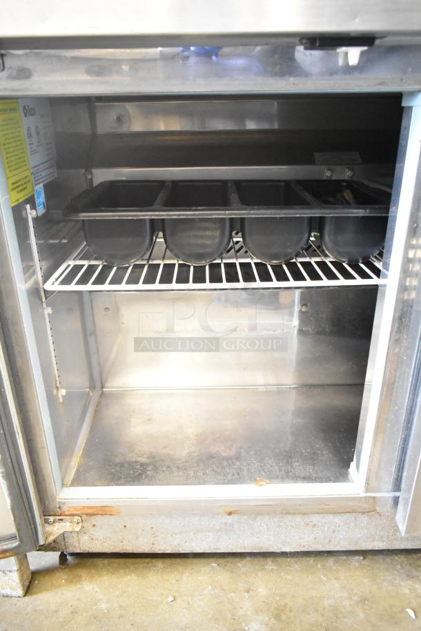 Ikon IUC48R 2-door undercounter cooler, 115 volts, 1 phase, some rust visible, interior shelving and label shown.