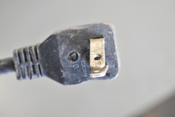 Close-up of the power plug from an Ikon IUC48R Commercial 2 Door Undercounter Cooler, showing prong details.