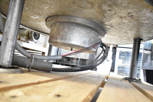 Cleveland KEL-100 commercial 100-gallon steam-jacketed electric kettle underside, showing wiring and base condition.