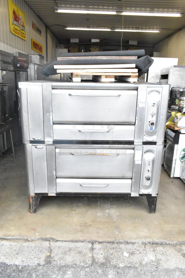 Two commercial gas-powered single burner pizza ovens with cooking stones, stainless steel, used condition, stackable.