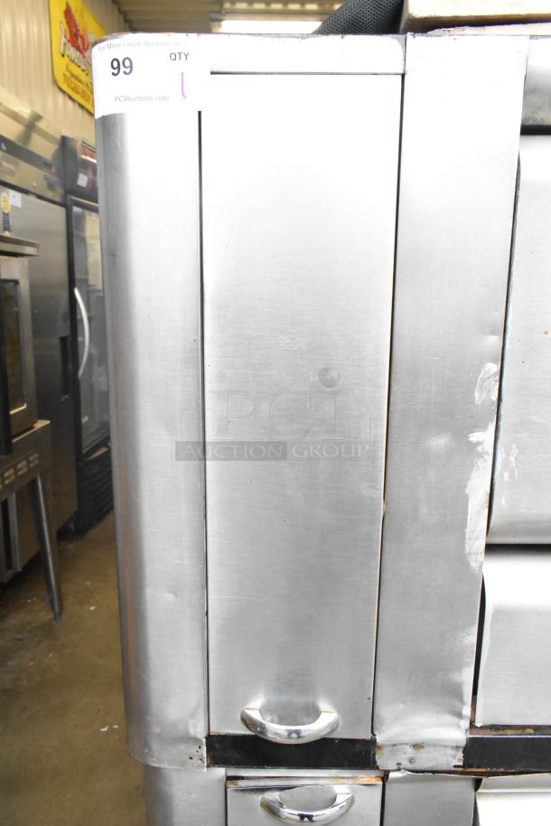 Two commercial gas-powered single burner pizza ovens with cooking stones, stainless steel, in good condition. Auction tag "99".