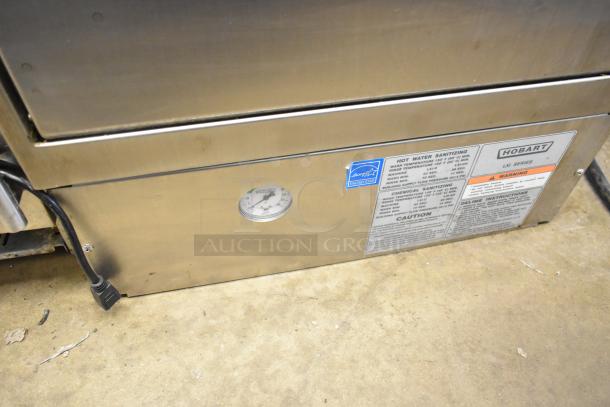 Hobart LXIH commercial undercounter dishwasher, 120/208-240 volts, 1 phase. Features visible labels and power cable.