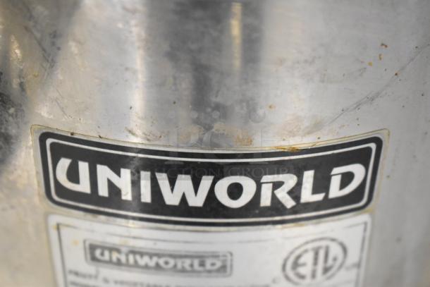 Uniworld UJC-720E countertop juice extractor, 110V, shows signs of use. Label indicates brand and model. Suitable for commercial use.