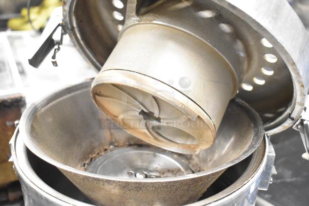 Uniworld UJC-720E commercial juice extractor, stainless steel, 110V, 1 Phase, used condition, open showing interior components.