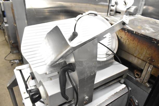 Avantco Commercial Countertop Meat Slicer, 115V, 1 Phase. Features a sharp blade and adjustable thickness. Signs of use visible.