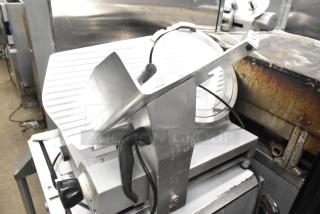 Avantco Commercial Countertop Meat Slicer, 115V, 1 Phase. Features a sharp blade and adjustable thickness. Signs of use visible.