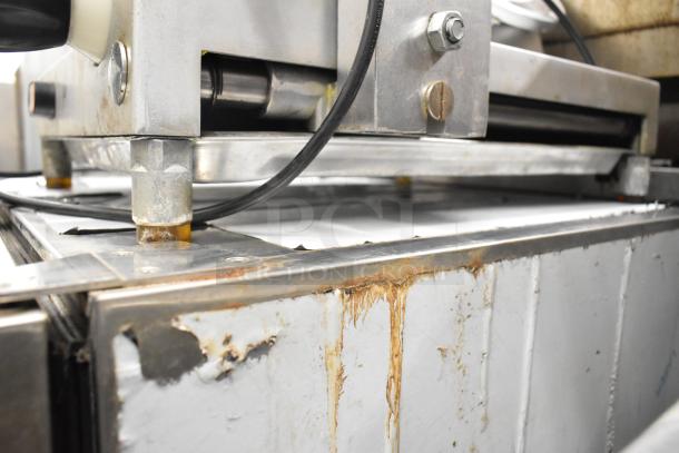 Avantco Commercial Countertop Meat Slicer, 115 Volts, 1 Phase, showing signs of wear with rust on metal base.