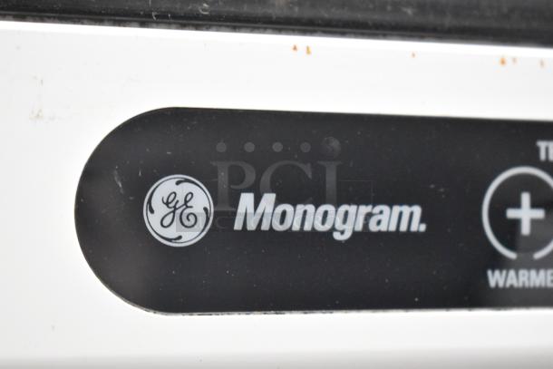 General Electric GE Monogram undercounter cooler, model ZDOD240PASS, with logo and control panel detail.