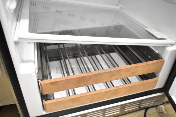 General Electric GE ZDOD240PASS Monogram cooler, single door, undercounter model, 115 volts, metal racks, good condition.