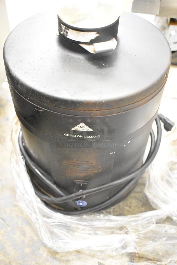 Mahlkonig K30ES/12 espresso grinder, no lid, visible wear. Markings "Grind on Demand," 115 volts, single-phase.