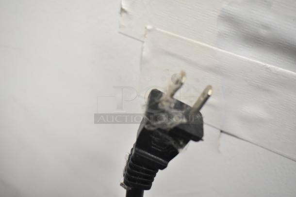 Power plug of a Home HME010387N Countertop Air Fryer Oven, showing some dust accumulation, in used condition.