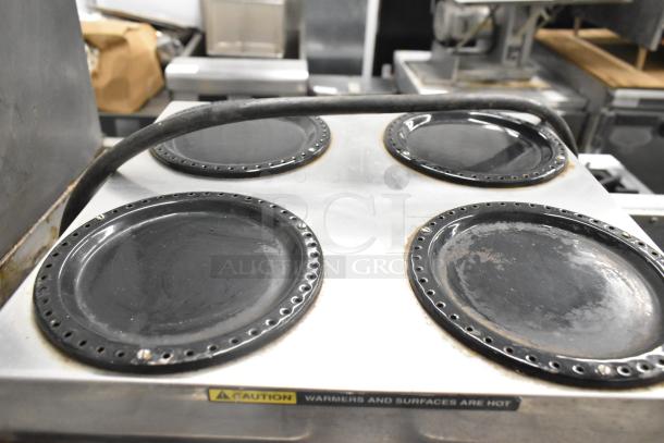 Bunn CWTF 4/2 TWIN coffee machine with six burners, visible wear, 120/240 volts, 1 phase. Caution label for hot surfaces.