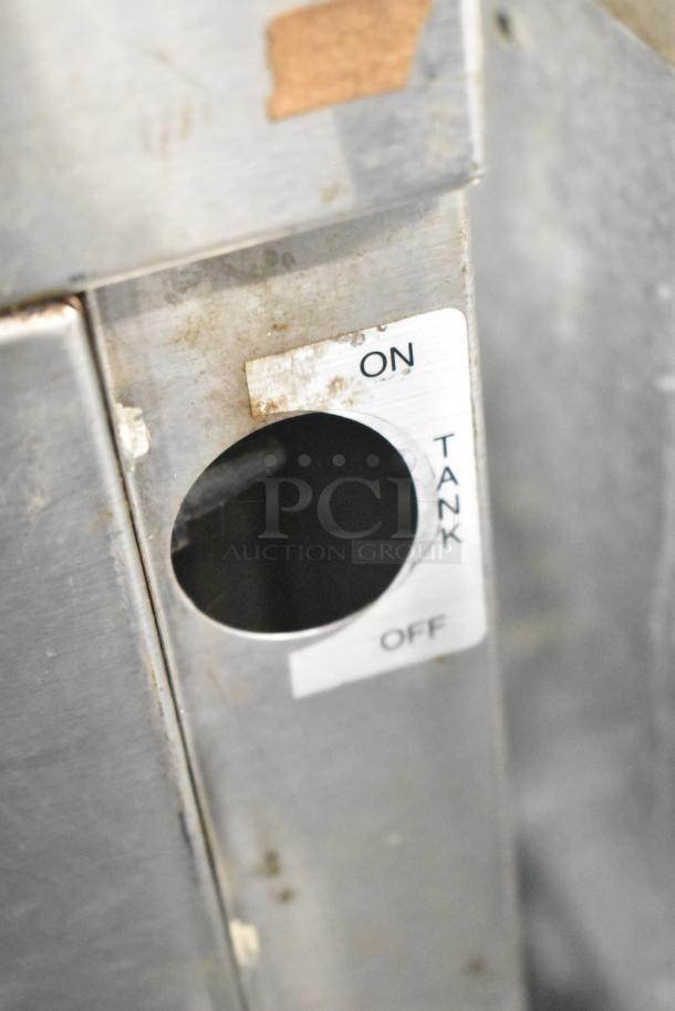 Close-up of Bunn CWTF 4/2 TWIN coffee machine control. Shows on/off tank label, indicating its commercial use.