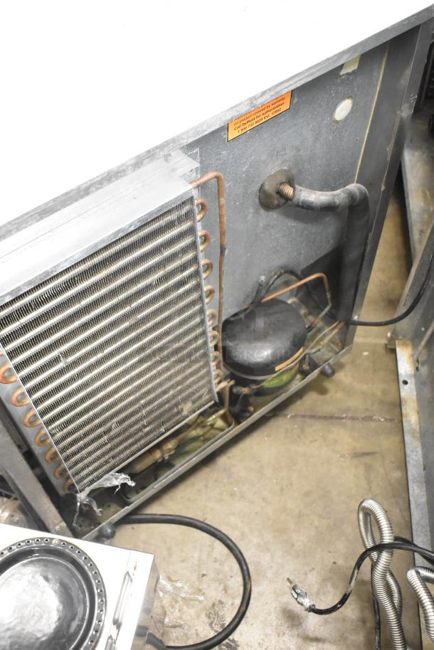 Delfield 406CA-DHL-DD1 commercial undercounter cooler, single door, 115 volts, 1 phase, visible compressor and piping.