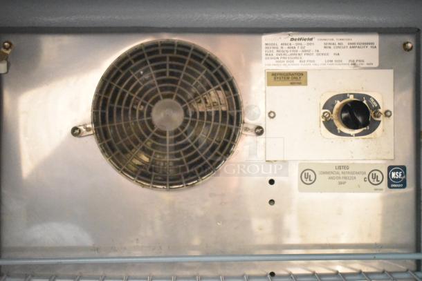 Delfield 406CA-DHL-DD1 undercounter cooler interior showing vent, control dial, and certification labels. Model info included.