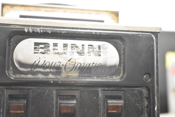 Bunn countertop 3 burner coffee machine, 15 volts, 1 phase. Visible wear on metal panel, logo intact.