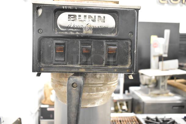Bunn countertop coffee machine with 3 burners, 15 volts, 1 phase, visible wear, Bunn Pour-O-Matic branding on the panel.