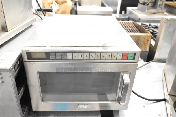 Panasonic NE-17523 commercial countertop microwave oven, 208/240 Volts, visible keypad, stainless steel exterior, used condition.