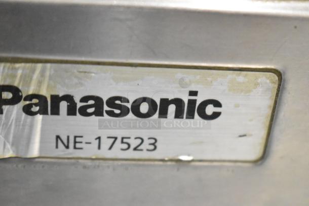 Panasonic NE-17523 Commercial Microwave Oven label close-up, showing model and branding, slight wear visible.