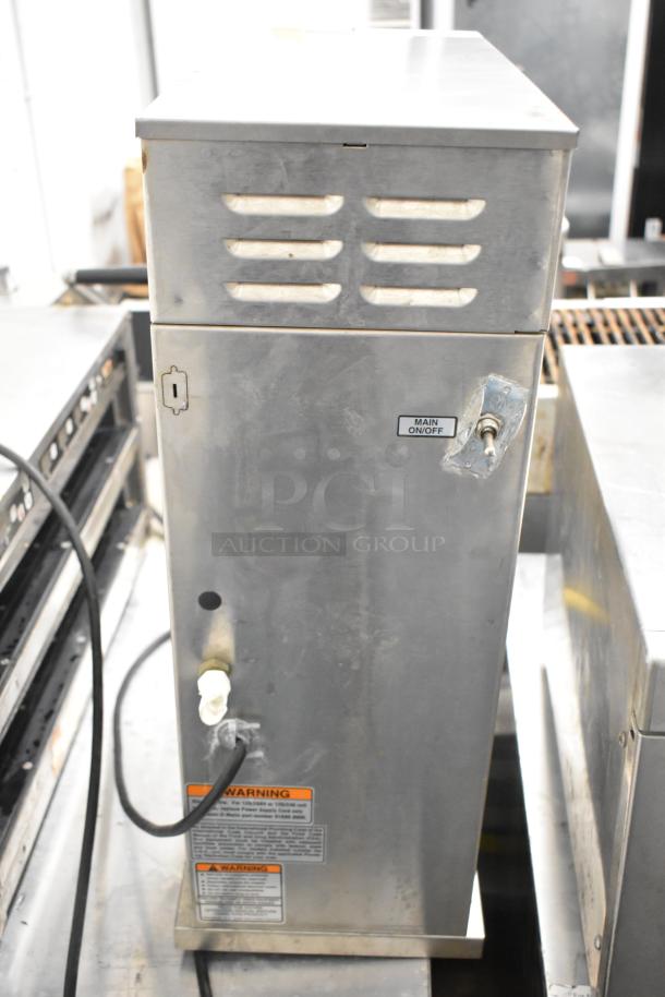 2018 Bunn AXIOM-DV-APS commercial coffee brewer, stainless steel, with hot water dispenser. Visible on/off switch; minor wear.