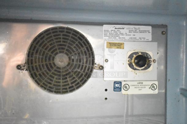 Delfield 406CA-DD1 undercounter cooler interior, showing fan, settings dial, and labels. Model info and certifications visible.