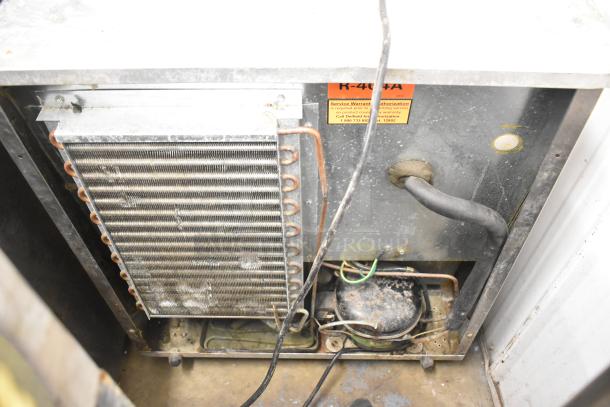 Delfield 406CA-DD1 commercial undercounter cooler, single door, 115 volts, visible internal components, fair condition.