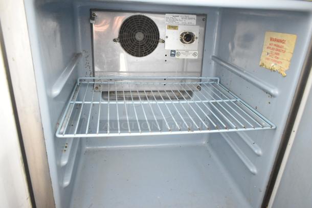 Delfield 406CA-DD1 undercounter cooler interior with wire shelf. Features 115 volts, 1 phase. Warning label visible.