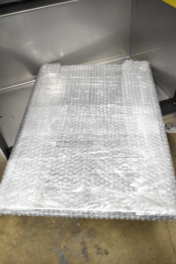 Brand new Kutano JUT 2 4D PT sandwich prep table wrapped in bubble wrap. 2022 model, 115V, on commercial casters.