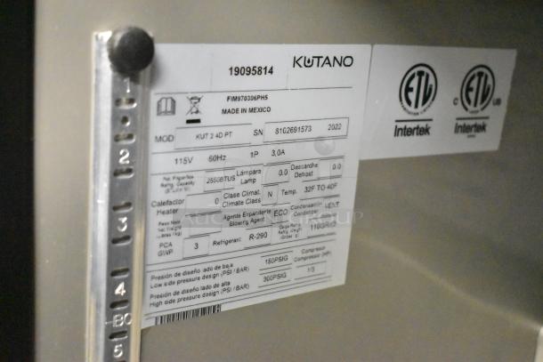 BRAND NEW 2022 Kutano JUT 2 4D PT Sandwich Salad Prep Table, 115V, 1 Phase, commercial casters, label indicates model and specs.