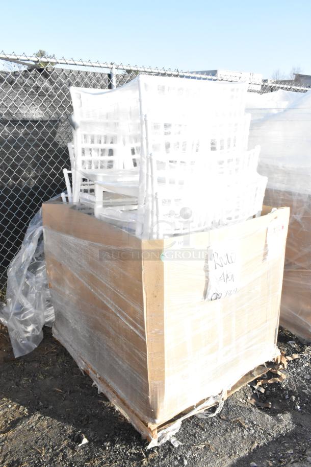 Stack of white resin Chiavari chairs by Lancaster Table & Seating, brand new scratch and dent, wrapped on a pallet.