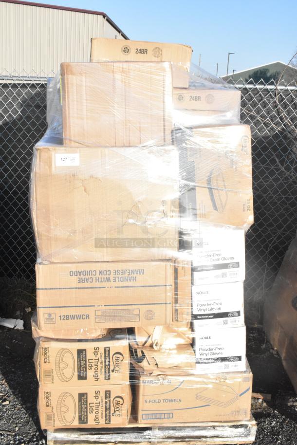 Pallet with assorted boxes of scratch and dent items, including Noble vinyl gloves, sip-through lids, and paper towels.
