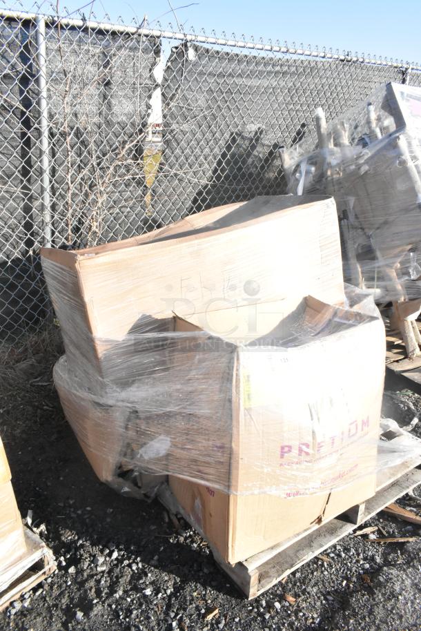 Pallet with three brand new scratch and dent items, including a stool and seat cushions, wrapped in plastic. Visible "FEB26-161" marking.