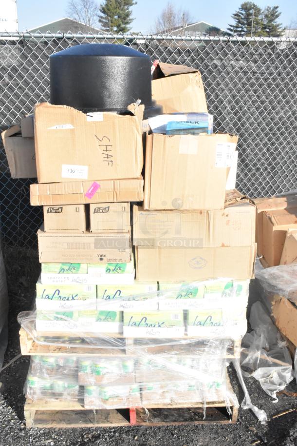 65 new scratch and dent items on a pallet, including La Croix sparkling water and other goods. Visible labels indicate contents.