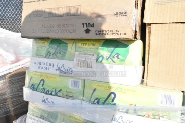 Stack of 12-pack La Croix Key Lime sparkling water boxes wrapped in plastic, part of scratch and dent auction lot.