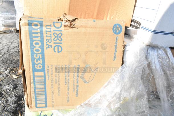 Cardboard box labeled "Dixie Ultra" and "Georgia-Pacific," contains 250 serviettes per package, 24 packages total. Box has visible dent.