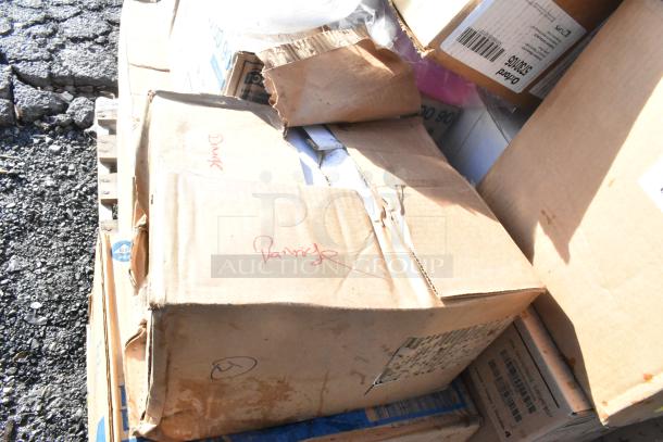 Stack of boxes with visible wear labeled "Damaged"; contains 15 scratch and dent items, including shelf liners.