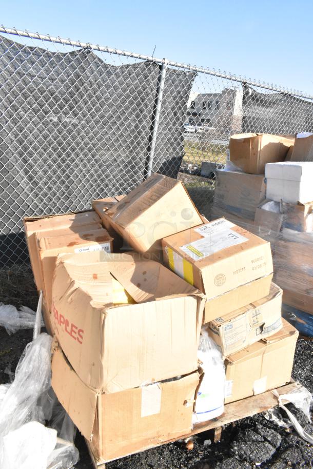 Boxes with scratch and dent shelf liners, various sizes. Some boxes labeled "Staples." Items appear new despite outer wear.