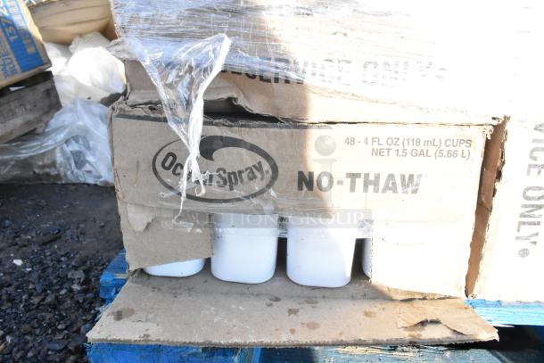 Cardboard box labeled "Ocean Spray NO-THAW" containing white cups. Box is slightly damaged.