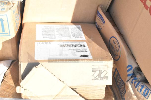 Cardboard box labeled "Diversey" with visible barcode, containing assorted new scratch and dent household items.