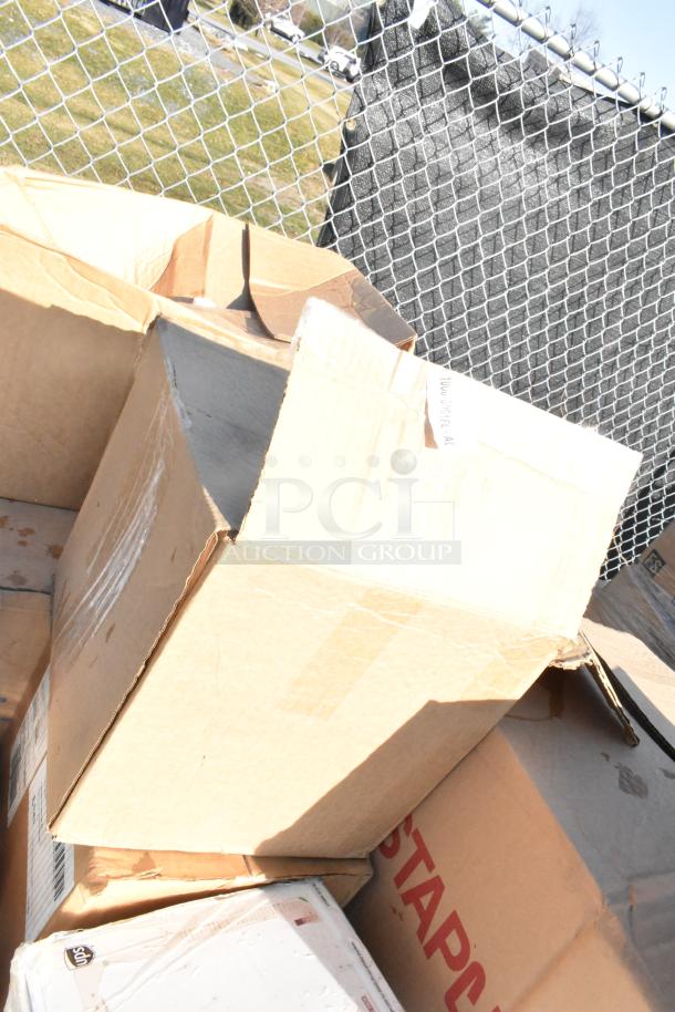 Cardboard boxes labeled "32 brand new scratch and dent items" including toilet seat covers, laundry bags, and power cleaner.