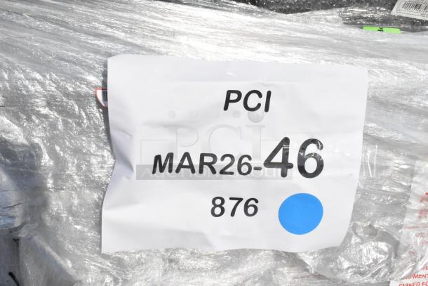 Plastic-wrapped bundle labeled "PCI MAR26-46 876," indicating 32 brand new scratch and dent items, including outdoor chairs.