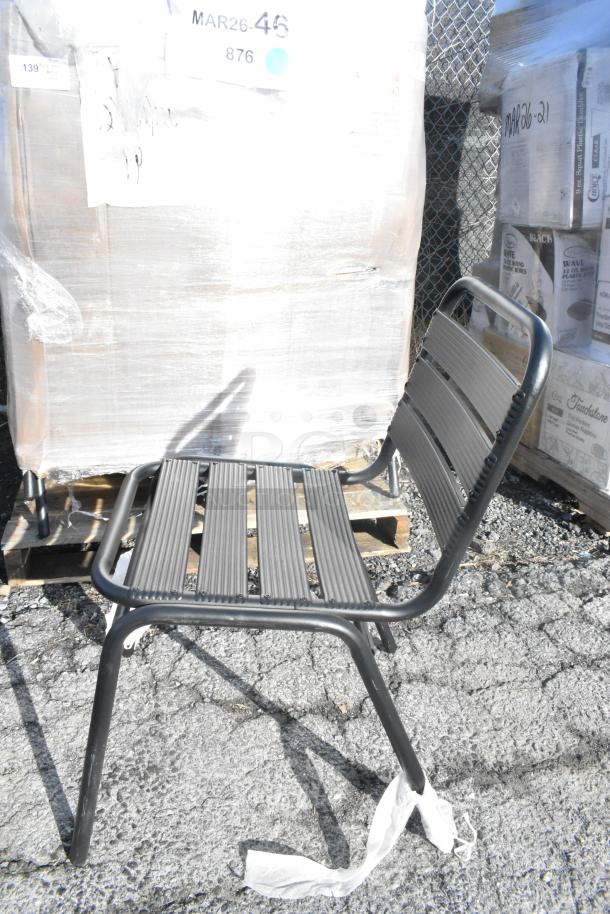 Lancaster black powder-coated steel outdoor side chair, new with minor scratches, shows durability and sleek design.