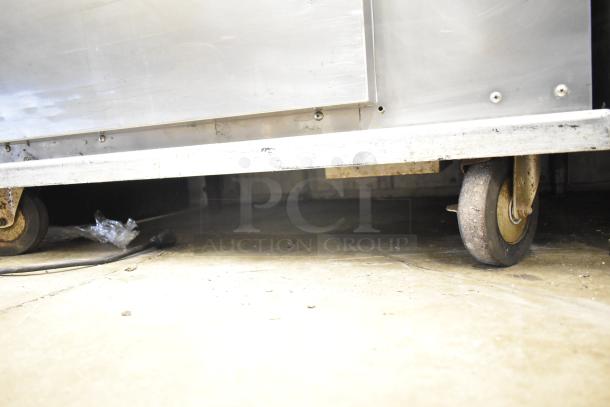 Plate Mate heated holding cabinet on commercial casters, visible wear, stainless steel, ideal for food service storage.