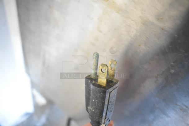 Blodgett convection oven plug with three-prong design shows corrosion on metal parts, indicating potential need for maintenance.