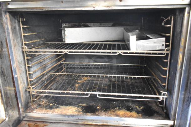 Blodgett commercial full-size convection oven with view-through doors, thermostatic controls, and metal legs. Visible wear inside.