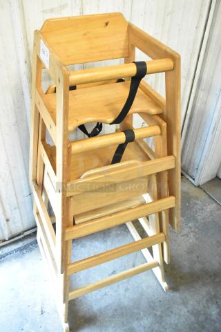 Set of 3 wooden high chairs, natural finish, stackable design, with safety straps, sturdy construction, item tag "157".